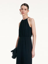 A lady wears a black halter top.